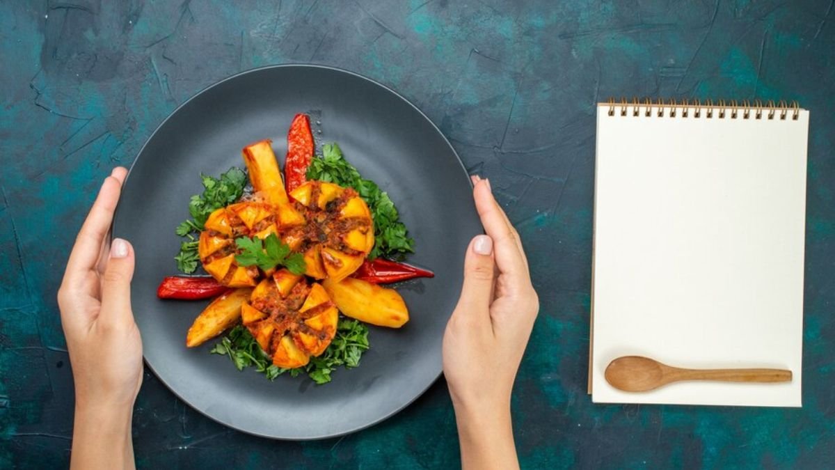 Food writer taking notes beside a plated dish