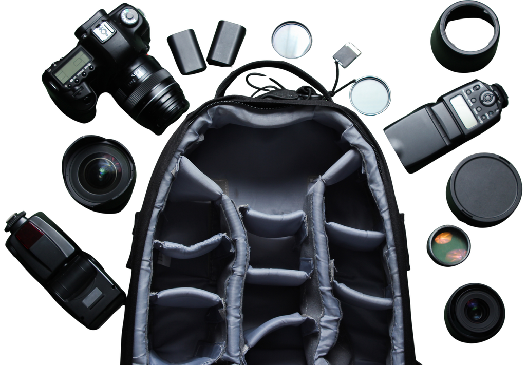 Open camera backpack surrounded by photography gear